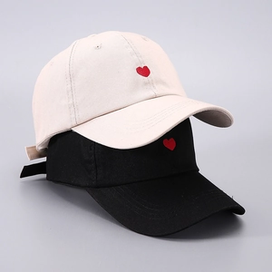 Set of black and beige cotton baseball caps with embroidered small red hearts