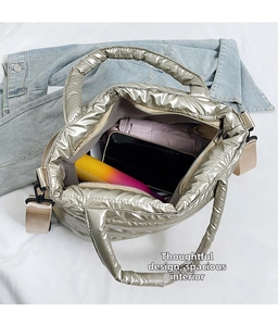 Interior view of metallic quilted tote bag showing space for phone, umbrella, and water bottle