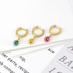 Macro detail of teardrop zircon hoop earrings with colorful enamel edging in gold finish