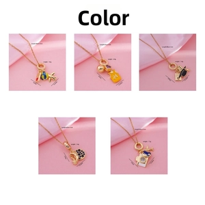 Detailed close-up of 18K gold plated necklaces featuring travel and basketball pendants