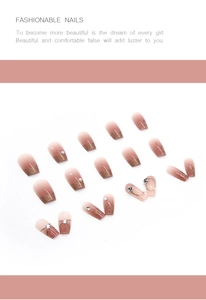 Detail of press-on nails featuring red gradient finish with pearls and rhinestones