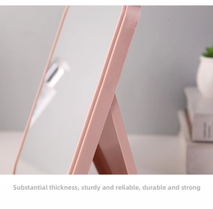 Detail view of the pink desktop makeup mirror showing its thick frame and sturdy support stand