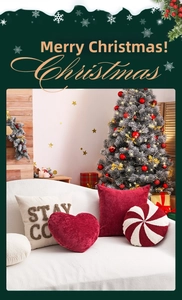 Detail of Christmas throw pillows set featuring red heart and embroidered candy cane motifs