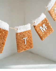 Detail of Christmas felt pocket banner with silver glitter letters and white fur trim