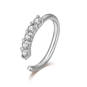 Detail of silver S-shape nose ring with five inset transparent sparkling gemstones