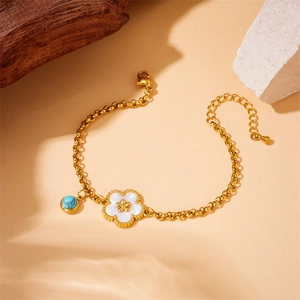 Gold stainless steel chain bracelet with white shell flower and turquoise bead charms