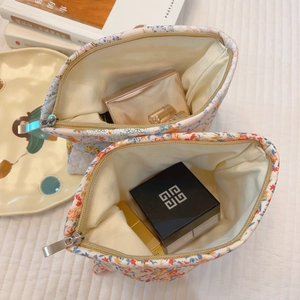 Floral cotton makeup bag with zipper closure and spacious interior for cosmetics