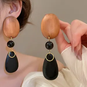 Vintage wooden drop earrings with black oval beads and gold metal links for women