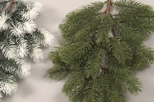 Close-up of frosted green pine branches with realistic snow texture for Christmas decor