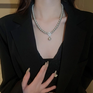 Close-up of elegant grey pearl necklace with water drop pendant on female model