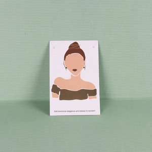 Close-up of green round stud earrings displayed on a white illustrative jewelry card