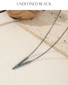 Macro view of vintage V-shaped necklace with black metal and turquoise gemstones