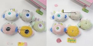 Close-up of colorful plush monster pins showing front design and back pin attachment details