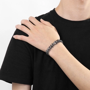 Detail of vintage spine skeleton bracelet in aged stainless steel on a person's wrist