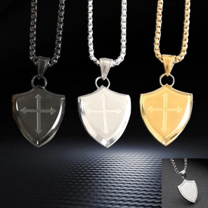 Detailed view of shield-shaped cross pendants with custom engraving on the back side