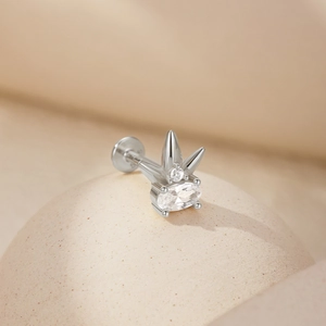 Detailed close-up of S925 silver heart crown piercing stud with sparkling zircon on a textured sphere