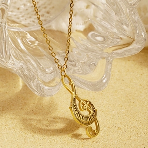 Creative music themed necklace with golden treble clef and piano key pendant for women