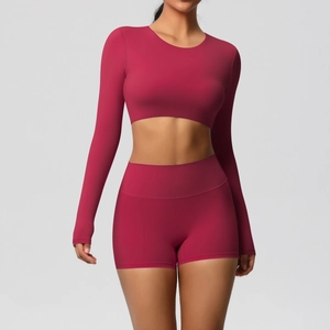 Detail of high-stretch seamless yoga set in berry red with ergonomic stitching and matte finish