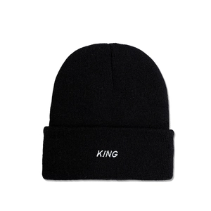 Close-up of KING embroidery on the cuff of a black ribbed knit beanie for winter