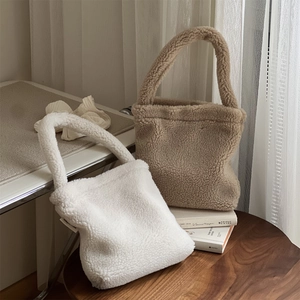 Winter teddy fleece tote bags in white and khaki shown on a wooden table setup