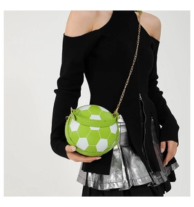 Detail of soccer ball crossbody bag with green and white panels and gold chain strap