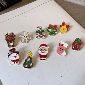 Set of 10 festive Christmas enamel pins featuring Santa, reindeer, and snowman designs