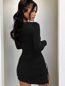 Detail of black long sleeve mini dress with adjustable side drawstring and ruched texture