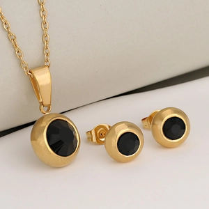 Golden stainless steel jewelry set featuring a necklace and stud earrings with black stones