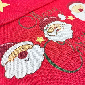 Detailed knit texture of a red Christmas table runner with Santa and star motifs