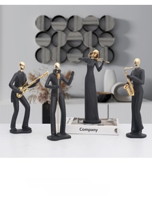 Close-up of abstract black and gold musician statues for modern home office decor