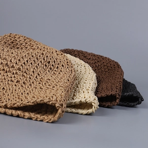 Detail of handmade woven bucket hats in four neutral colors for a stylish summer look