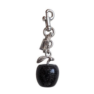 Detail of black glittery apple pendant with silver metal chain and hook for bags