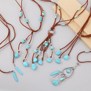 Detail of bohemian turquoise necklaces with suede cords and silver leaf pendants