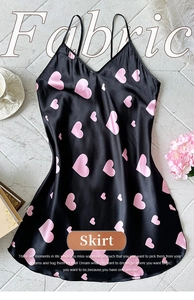 Detail of black satin sleepwear with pink heart prints and elegant V-neckline design
