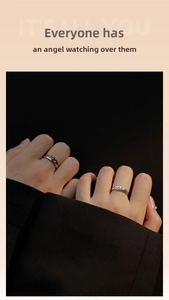 Detail of angel and demon couple rings featuring black wing and silver wing with diamond
