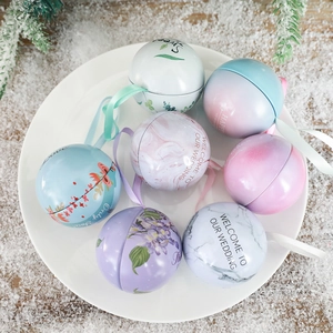 Set of 6 spherical tin wedding gift boxes with festive patterns on snowy background