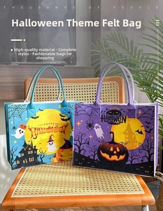 Detail of Halloween felt tote bags featuring pumpkin and ghost prints on a chair
