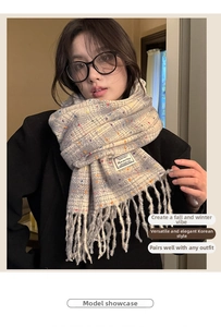 Detail shot of multicolor polka dot scarf with long tassels and soft cashmere-like texture
