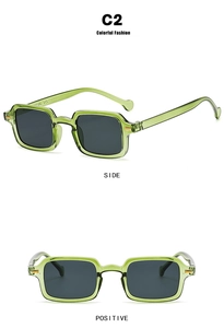 Detail view of transparent green rectangular sunglasses in shade C2 with grey lenses