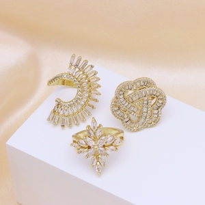 Three-piece gold plated ring set with cross and floral motifs featuring zircon stones