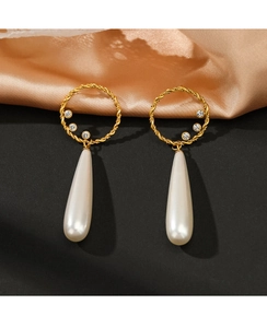 Detail of 14K gold plated hoop earrings with sparkling rhinestones and teardrop pearl