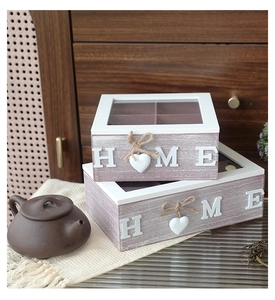 Detailed view of two rustic wooden storage boxes with glass lids and HOME lettering