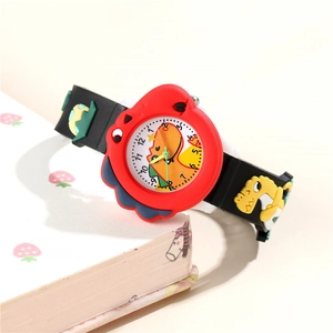 Close-up of kids dinosaur watch with 3D silicone strap beside a strawberry notebook