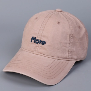 Close-up of blue More embroidery on pink washed cotton baseball cap with curved brim