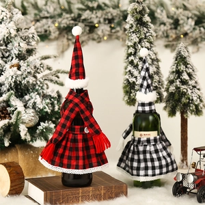Close-up of red and white plaid Christmas wine bottle covers with mini hats and scarves