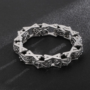 Detailed close-up of retro stainless steel bracelet with X-shaped links and relief patterns