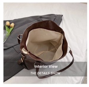Interior detail of large brown tote bag showing spacious lining and zipper closure