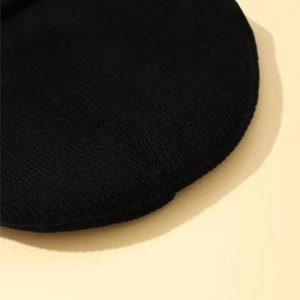 Classic black knitted beanie hat with fine stitching and warm thermal texture for winter