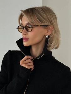 Detail of black ribbed knit sweater with a metal half-zip and stylish high collar design