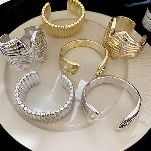 Minimalist metallic textured open bangles in gold and silver finish with spiral patterns